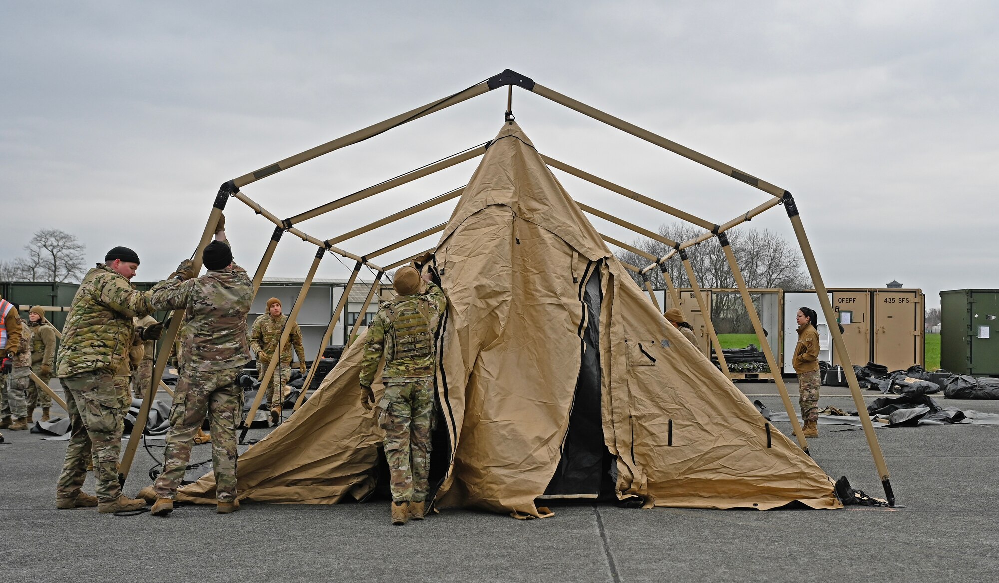 Members of the 435th Contingency Response Group begin Exercise Agile Bison 23-1 by building tents in preparation for their upcoming mission at Chièvres Air Base, Belgium, March 6, 2023. By executing the exercise, the 435th CRG will establish an expeditionary airfield while maintaining force protection during high threat levels.
