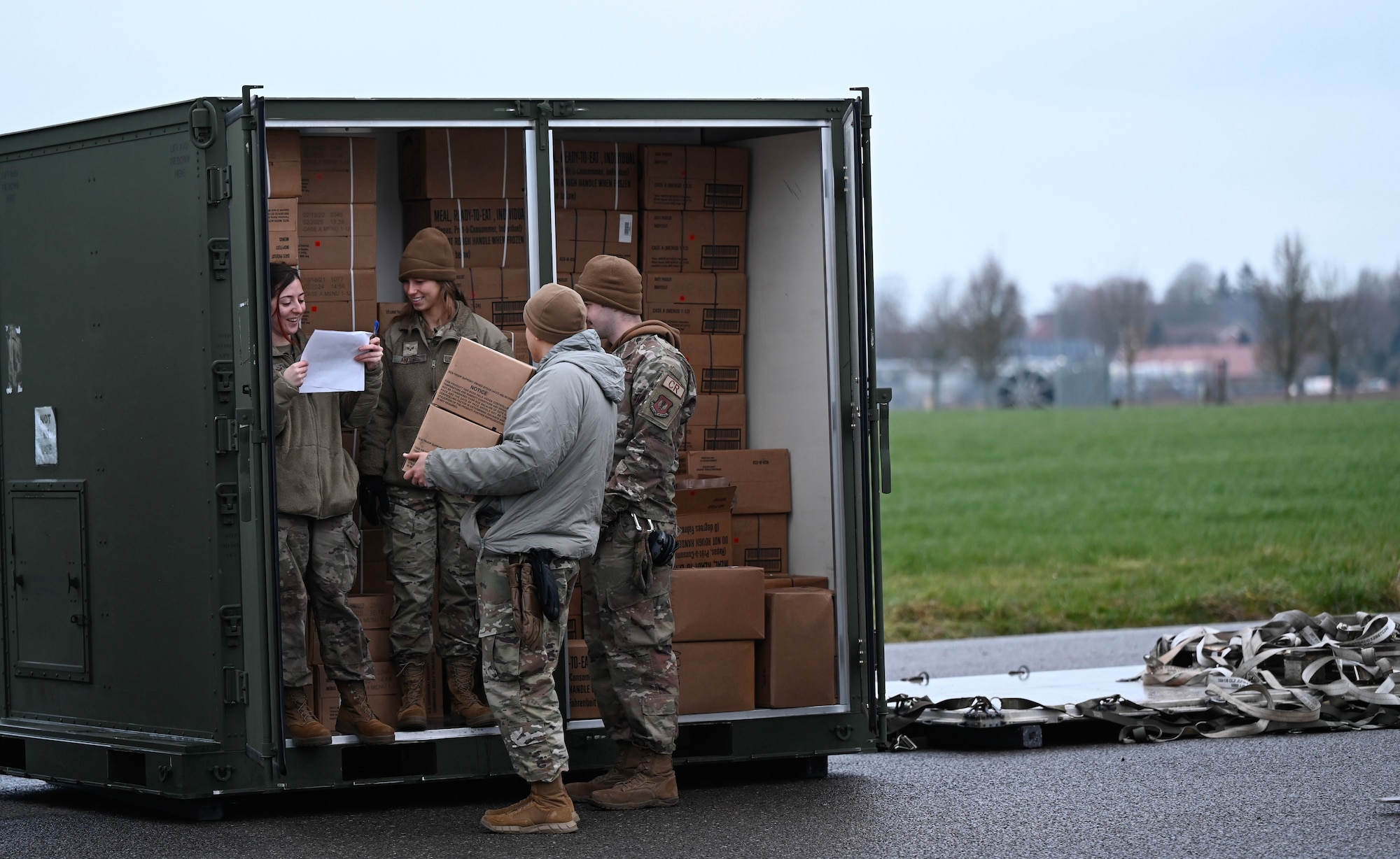 Members of the 435th Contingency Response Group hand out a box of Meals Ready-To-Eat for use during Exercise Agile Bison 23-1 at Chièvres Air Base, Belgium, March 7, 2023.  During the exercise, the 435th CRG trains to establish an expeditionary airfield using NATO allies and partner bases along with the group’s own personnel, logistics and equipment, while also maintaining force protection during high threat levels.