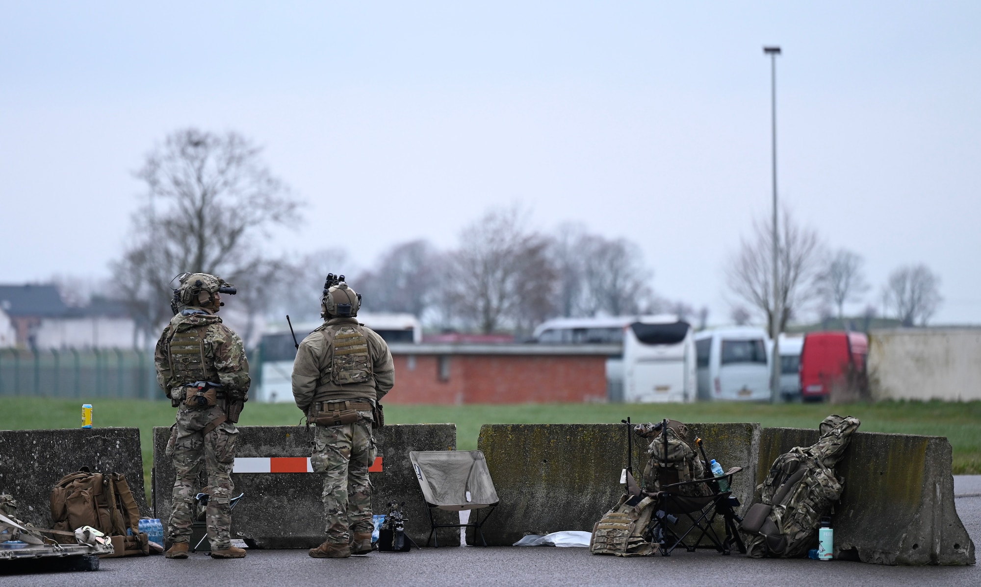 U.S. Air Force contingency response team members from the 435th Security Forces Squadron man a security checkpoint at Chièvres Airfield in Belgium, during Exercise Agile Bison 23-1, March 7, 2023. By executing the exercise, the 435th Contingency Response Group trained to establish an expeditionary airfield using NATO allies and partner bases along with the CRGs own personnel, logistics and equipment; all while maintaining force protection during high threat levels.