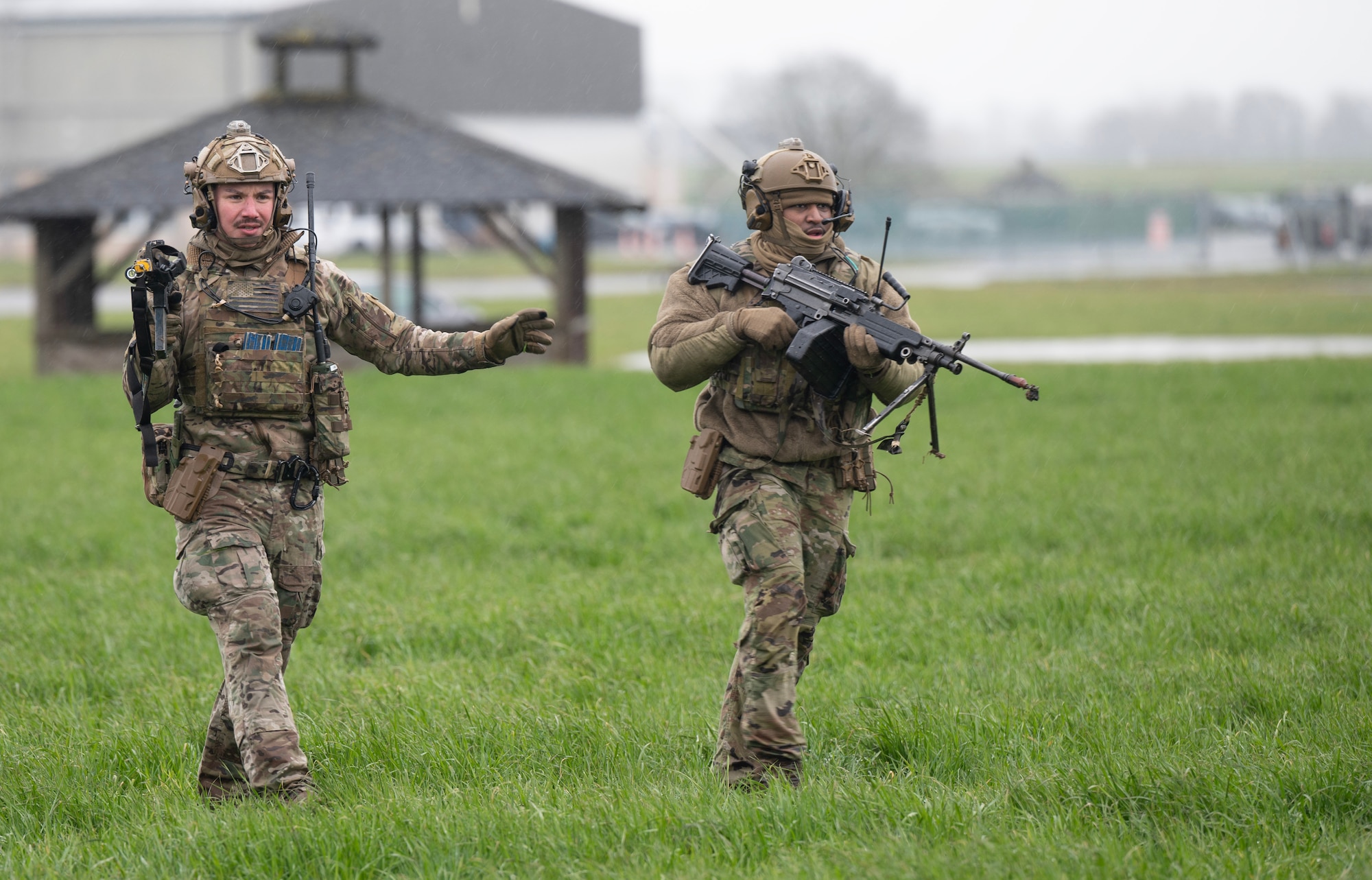 U.S. Air Force Staff Sgt. Jose Gonzalez, left, and Staff Sgt. Quinton Burts, right, 435th Security Forces Squadron team members, assault  objects during a deliberate attack drill as part of Exercise Agile Bison 23-1 at Chièvres Air Base, Belgium, March 7, 2023. The 435th SFS mission is to secure, protect and defend Air Force weapons systems, air base assets, personnel and resources.