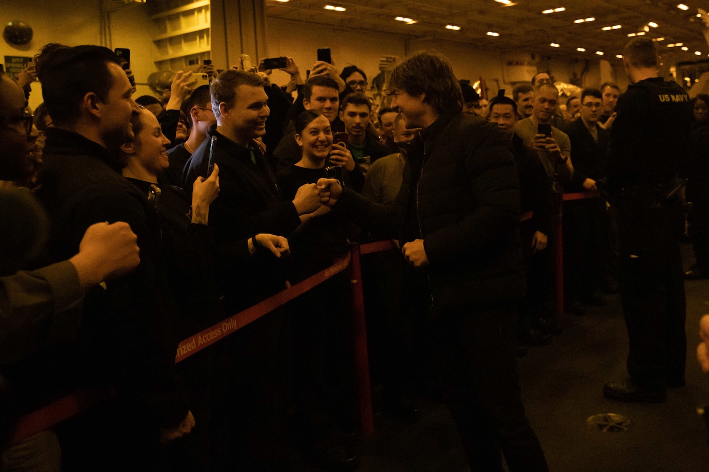 ADRIATIC SEA (March 2, 2023) Tom Cruise fist bumps a Sailor during a meet-and-greet aboard the Nimitz-class aircraft carrier USS George H.W. Bush (CVN 77), March 2, 2023. The George H.W. Bush Carrier Strike Group is on a scheduled deployment in the U.S. Naval Forces Europe area of operations, employed by U.S. Sixth Fleet to defend U.S., allied and partner interests.