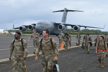 Total Force Airmen from the 154th and 15th Aircraft Maintenance Groups arrive at the Pacific Missile Range Facility at Barking Sands, Hawaii, March 7, 2023. Aircraft armament systems crews flew to Kauai on a C-17 Globemaster III to help receive, rearm and launch fighter aircraft within a condensed time window.