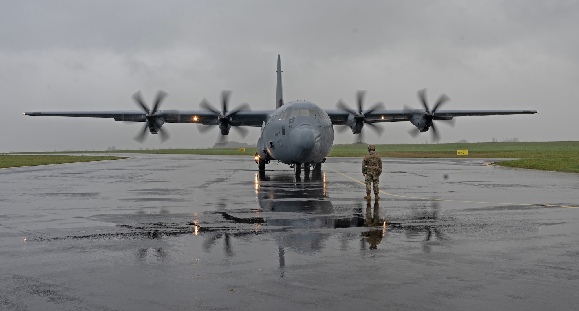 U.S. Air Force Staff Sgt. David Adams, 435th Contingency Response Squadron contingency response aerospace maintenance journeyman, marshals a C-130J Super Hercules cargo aircraft assigned to Ramstein Air Base, Germany, at Chièvres Air Base, Belgium, during Exercise Agile Bison, March 9, 2023.