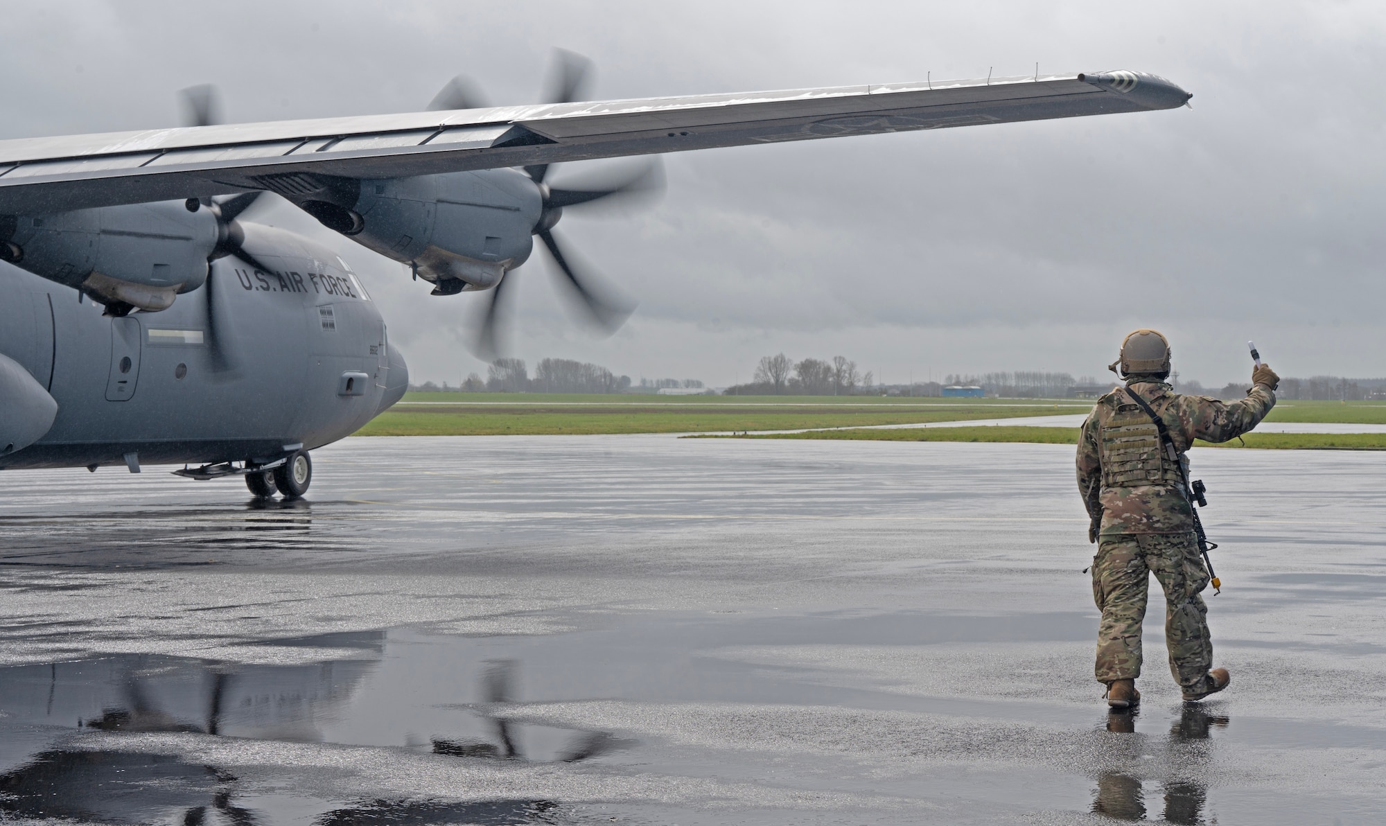U.S. Air Force Senior Airman Freddyjames Atwood, 435th Contingency Response Squadron contingency response aerospace maintenance craftsman, marshals a C-130J Super Hercules cargo aircraft prior to taking off at Chièvres Air Base, Belgium, during Exercise Agile Bison, March 9, 2023.