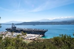 (March 10, 2023) The Nimitz-class aircraft carrier USS George H.W. Bush (CVN 77), along with the embarked staff of Carrier Strike Group 10, arrives in Souda Bay, Crete for a scheduled port visit, March 10, 2023. The George H.W. Bush Carrier Strike Group is on a scheduled deployment in the U.S. Naval Forces Europe area of operations, employed by U.S. Sixth Fleet, to defend U.S., allied, and partner interests. NSA Souda Bay is an operational ashore installation which enables and supports U.S., Allied, Coalition, and Partner nation forces to preserve security and stability in the European, African, and Central Command areas of responsibility.