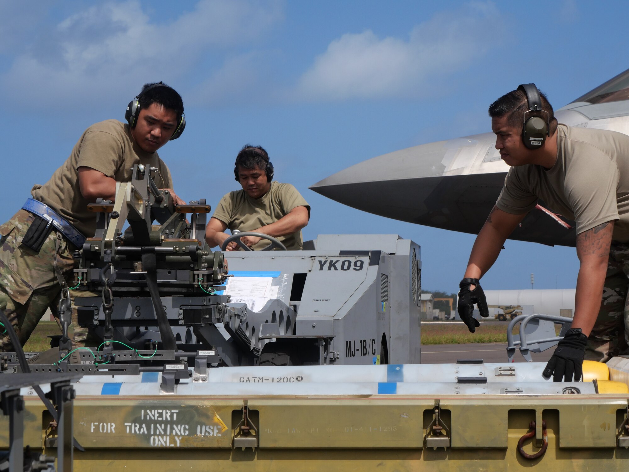 A Hawaii Air National Guard weapons crew from the 154th Aircraft Maintenance Squadron arms an F-22 Raptor with inert munitions at the Pacific Missile Range Facility, Barking Sands, Hawaii, March 8, 2023.