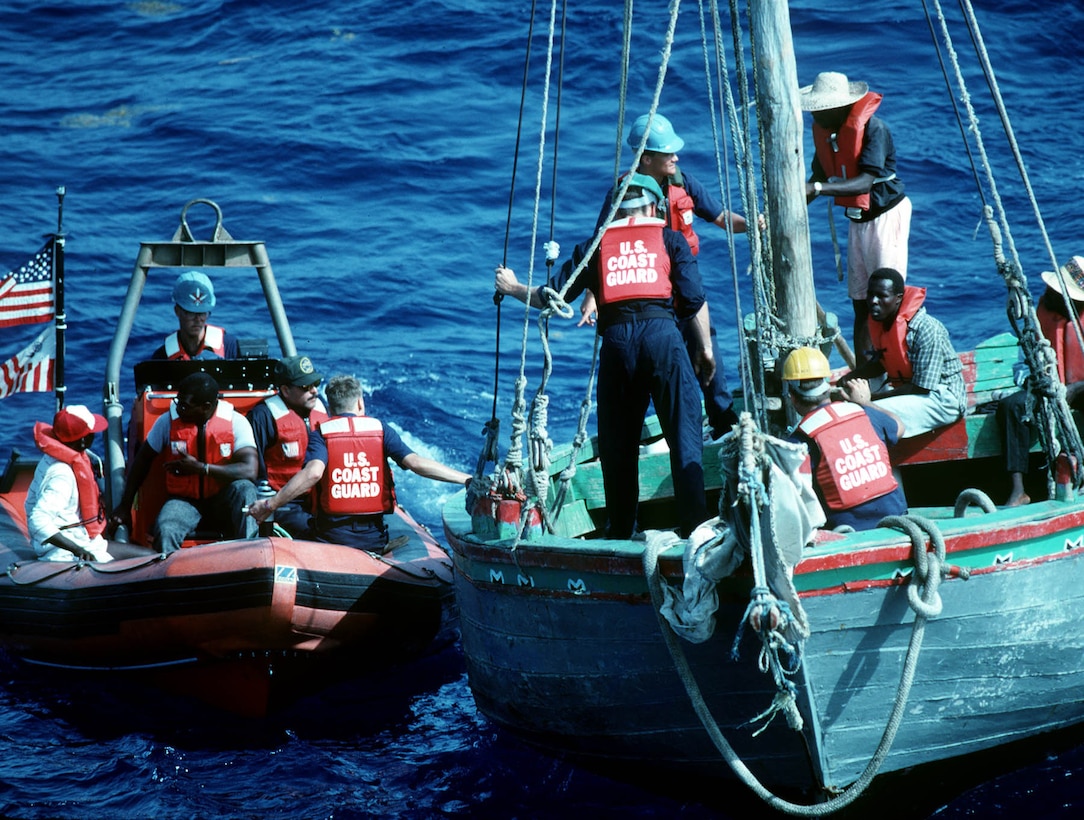 A smallboat from the U.S. Coast Guard cutter Dauntless prepare to board a vessel carrying Haitian migrants.