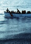 A group of Haitians are picked up by the USCGC Dauntless' motor surf boat.