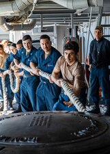 Sailors assigned to the Nimitz-class aircraft carrier USS George H.W. Bush (CVN 77), heave line as the ship, along with the embarked staff of Carrier Strike Group (CSG) 10, arrives in Souda Bay, Crete, for a scheduled port visit March 10, 2023.