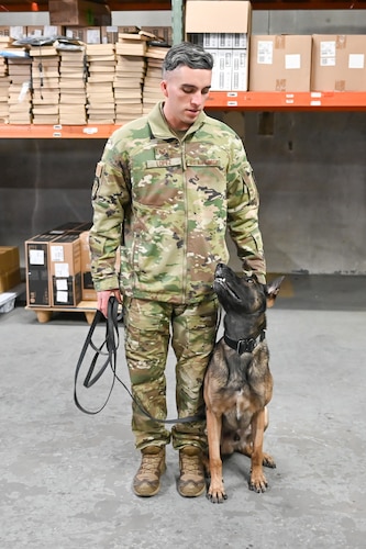 Military working dog Bak awaits a command from his handler Staff Sgt. Edward Lopez, 75th Security Forces Squadron, during explosives detection training