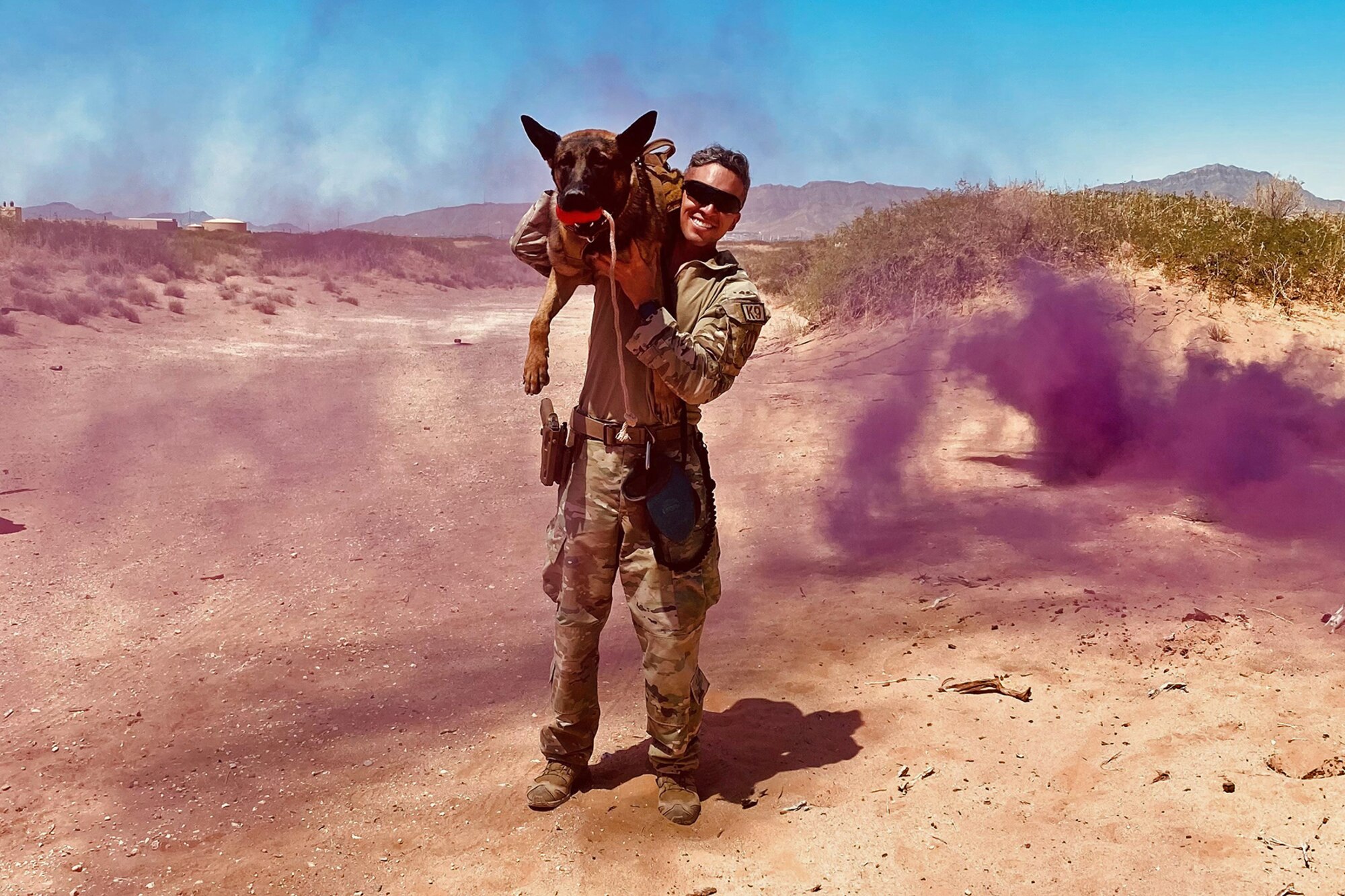 Staff Sgt. Edward Lopez and military working dog Bak, 75th Security Forces Squadron, pose at Al Dhafra Air Base