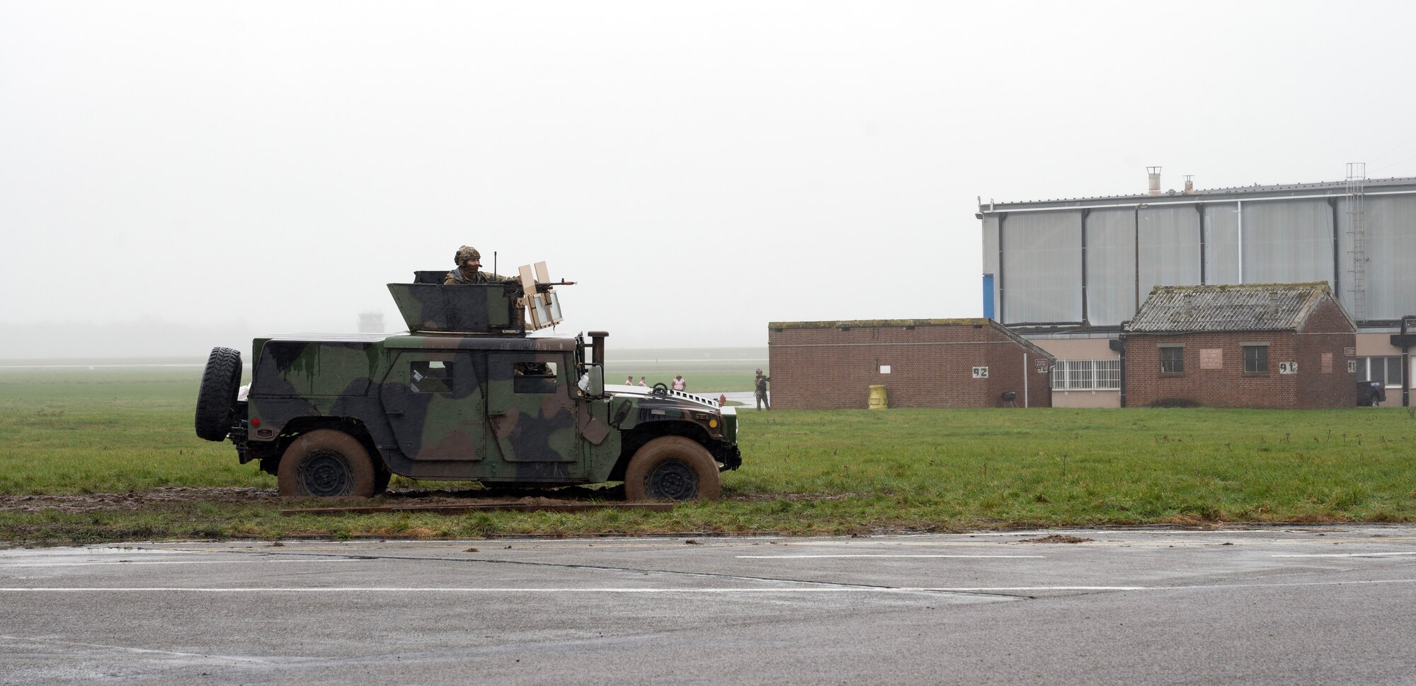 A gunner sits within a turret of a humvee