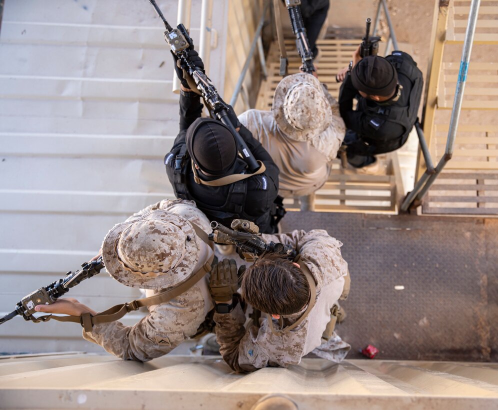 OMAN (February 18, 2023) – U.S. Marines assigned to Fleet Anti-Terrorism Security Team Central Command (FASTCENT) and members of the Royal Omani Police Special Task unit practice clearing multi-floor structures during close quarter combat (CQB) training as part of exercise Invincible Sentry 23 in Oman, Feb 18. IS23 is a recurring exercise held with different partner nations each year within U.S. Central Command’s area of responsibility to evaluate the readiness and capabilities of U.S. and Omani forces responding to a regional emergency. (U.S. Marine Corps photo by Staff Sgt. Benjamin McDonald)