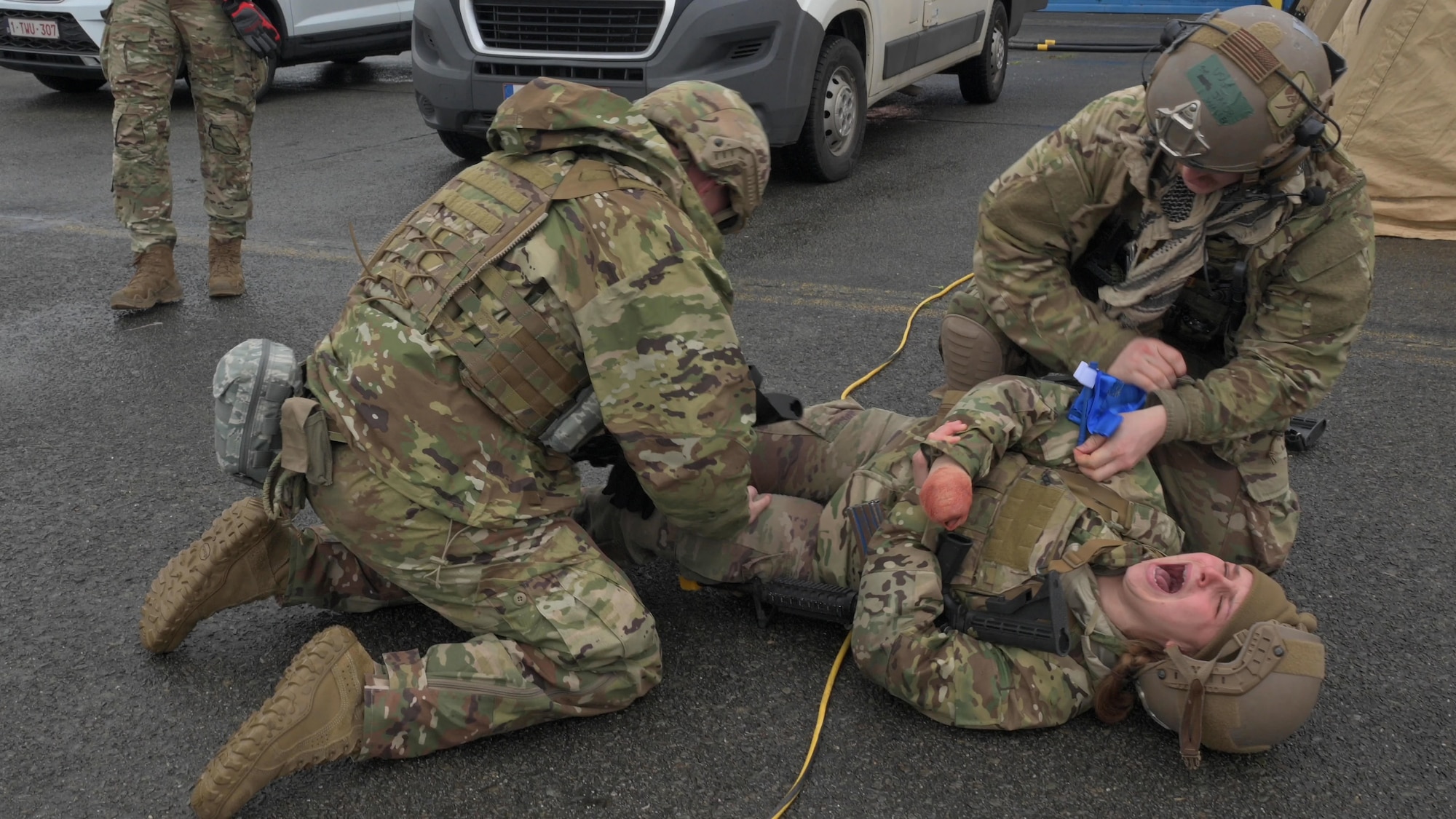 U.S. Air Force Staff Sgt. Cecilia Bak, 435th Contingency Response Squadron mobile aerial port supervisor, receives simulated quick, medical treatment following a scenario-based accident during Exercise Agile Bison at Chièvres Air Base, Belgium, March 9, 2023.