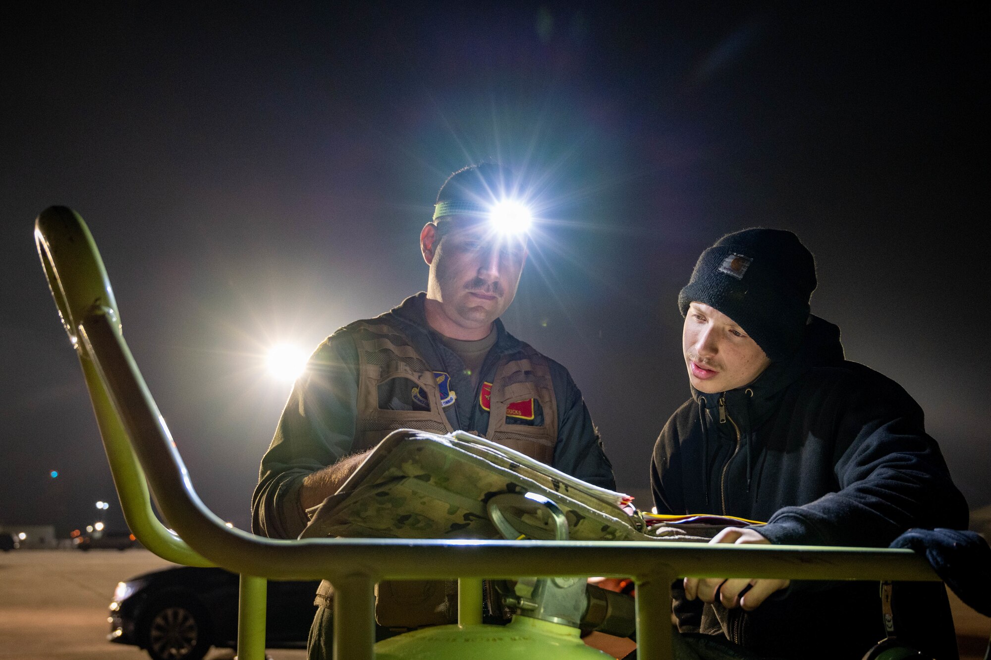 Lt. Col. Ryan Loucks, 23rd Expeditionary Bomb Squadron Commander, reads over the maintenance log with a crew chief at Morón Air Base, Spain, Mar 8, 2023. Bomber Task Force missions enable crews to maintain a high state of readiness proficiency, and validate our always-ready, global strike capability. (U.S. Air Force photo by Airman 1st Class Alexander Nottingham)