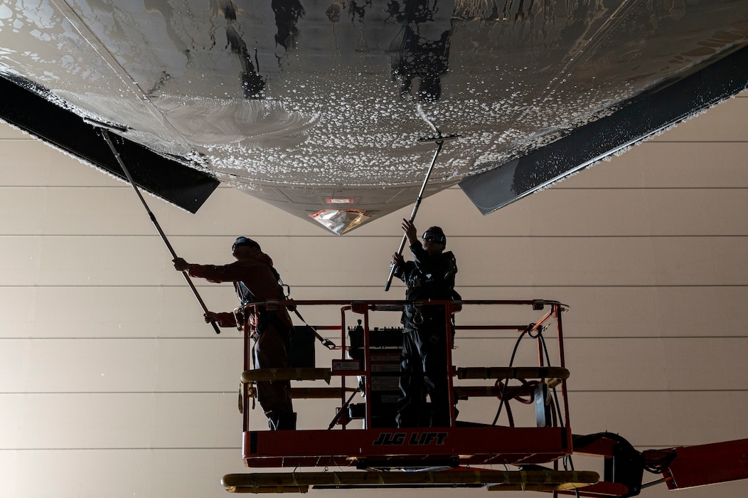 U.S. Air Force Tech. Sgt. David Acly and Staff Sgt. Stephen Minter, aircraft maintainers with the 167th Maintenance group, scrub the underside of a C-17 Globemaster III aircraft during a corrosion prevention wash at the 167th Airlift Wing, Martinsburg, West Virginia, Mar. 5, 2023