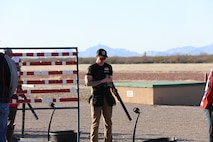 Man inspects his shotgun during a match in Tucson, Arizona