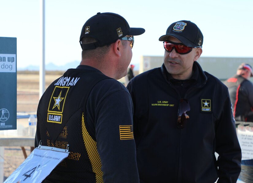 2 men talk outside during a skeet match in Tucson, Arizona