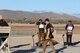 Man with shotgun shoots a clay target.