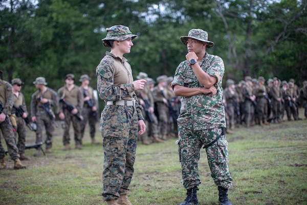 Marine Corps Capt. Marina Hierl speaks with a Malaysian service member