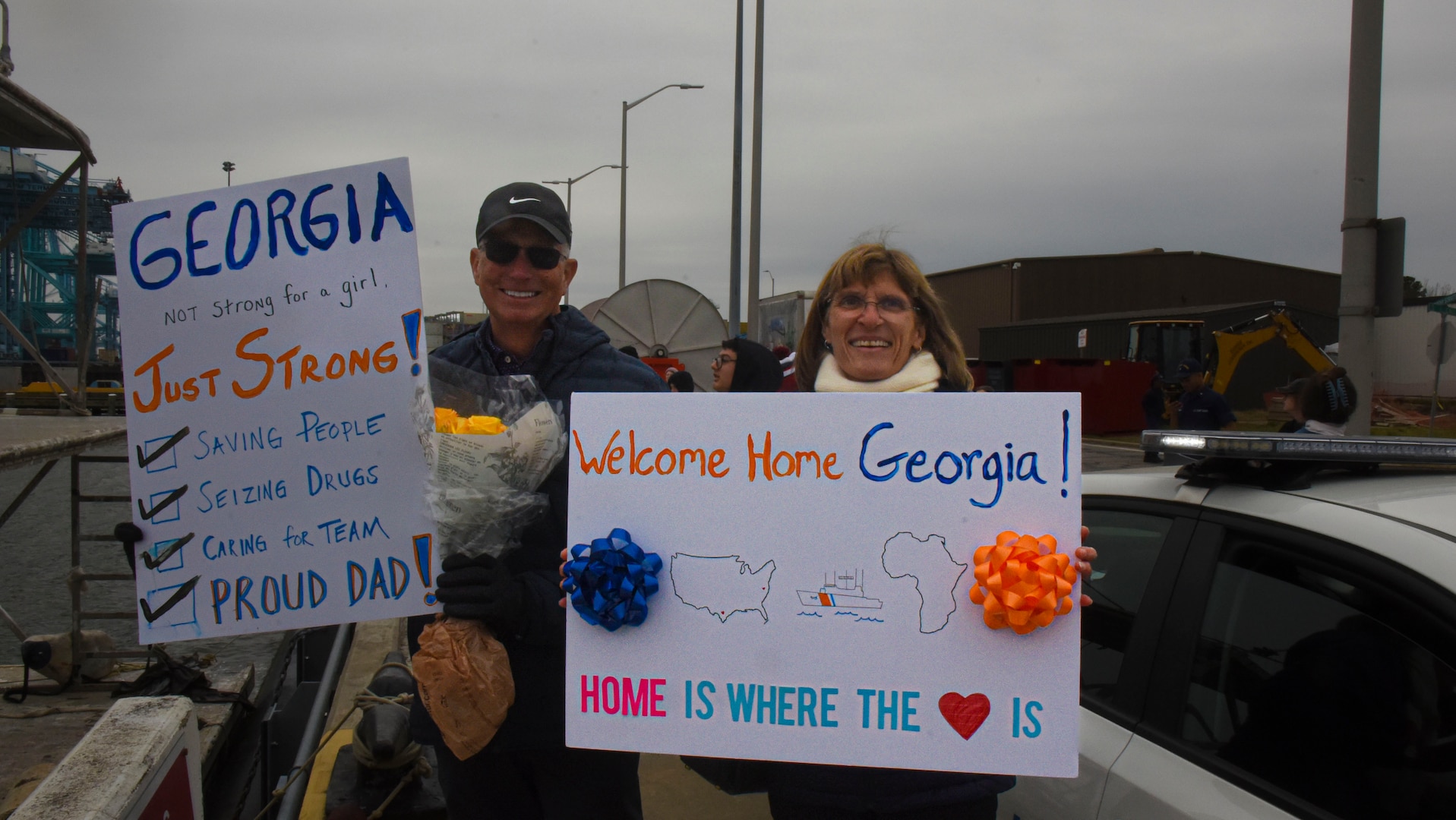 Family members of the USCGC Spencer's (WMEC 905) crew hold welcome home signs at the pier during the cutter's return to home port March 10, 2023, in Portsmouth, Virginia. Spencer returned home following an 88-day deployment in the U.S. Naval Forces Europe-Africa area of operations, employed by the U.S. Sixth Fleet and Combined Task Force 65, to defend U.S., allied and partner interests. (U.S. Coast Guard photo by Petty Officer 3rd Class Kate Kilroy)