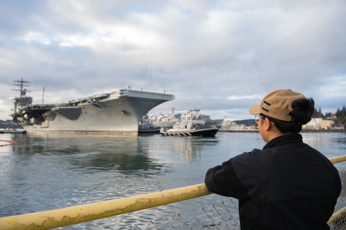 Machinist’s Mate 3rd Class Jazz Belocora watches as the aircraft carrier USS Nimitz (CVN 68) departs homeport in Bremerton, Washington Nov. 28, 2022. Nimitz provides the national command authority flexible, tailorable warfighting capability as the flagship of a carrier strike group that maintains maritime stability and security to ensure access, deter aggression and defend U.S., allied and partner interests. (U.S. Navy photo by Mass Communication Specialist Seaman Sophia H. Brooks)