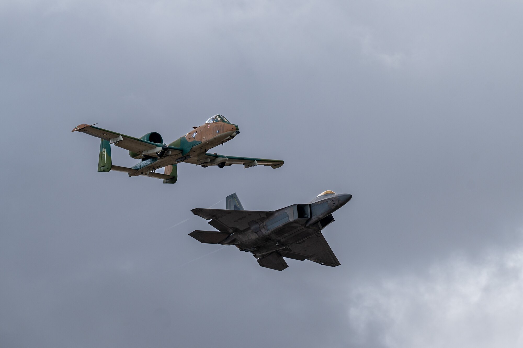 A photo of two aircraft flying in a formation.