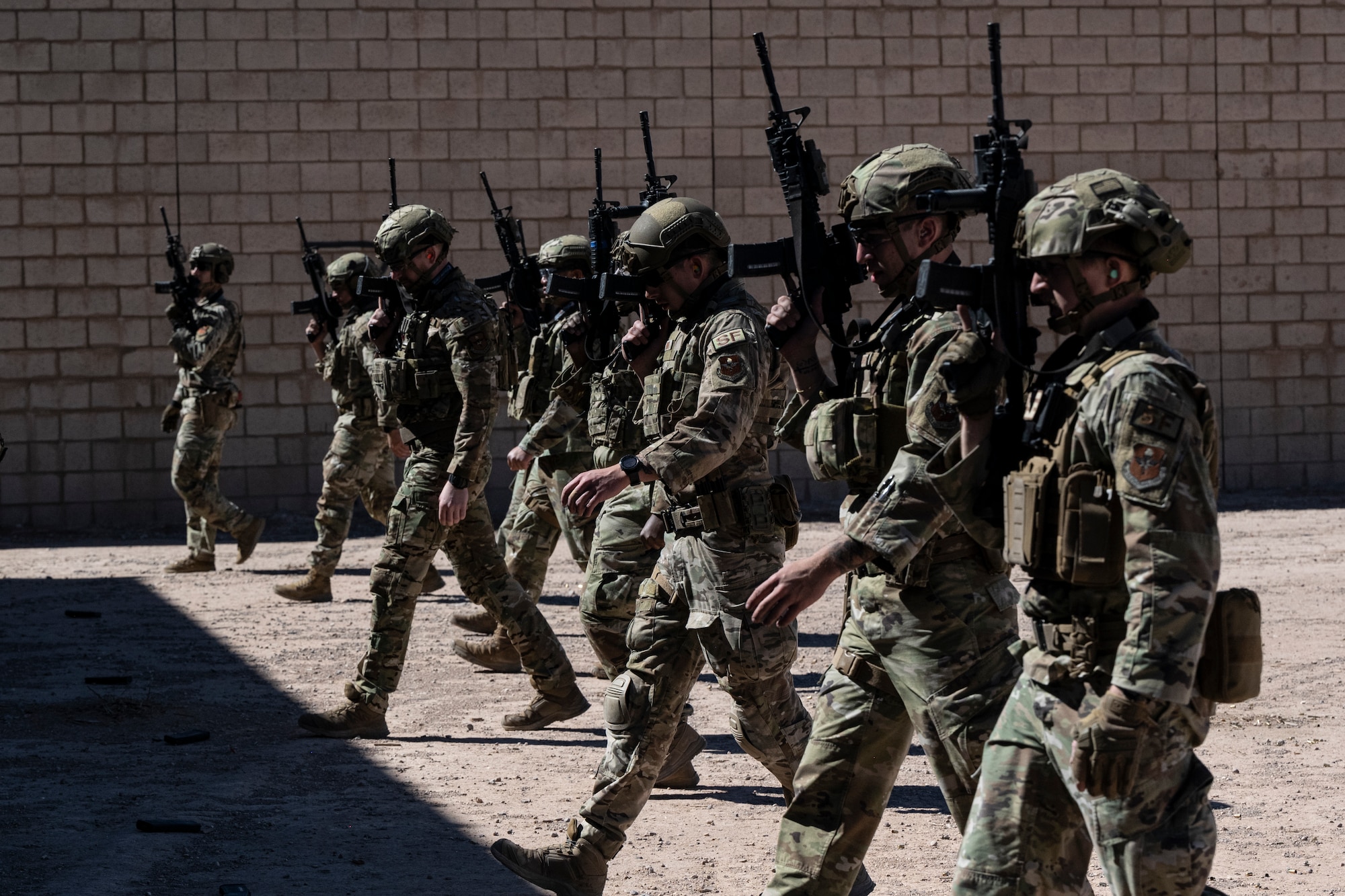 Airmen from the 49th Security Forces Squadron reposition themselves for a dynamic weapons drill at the combat arms training range during the first-ever Fire Team Leaders Course at Holloman Air Force Base, New Mexico, Feb. 27, 2023. Training at CATM was optimal for live-fire weapons exercises and provided an opportunity for Airmen to learn weapon safety. (U.S. Air Force photo by Senior Airman Antonio Salfran)