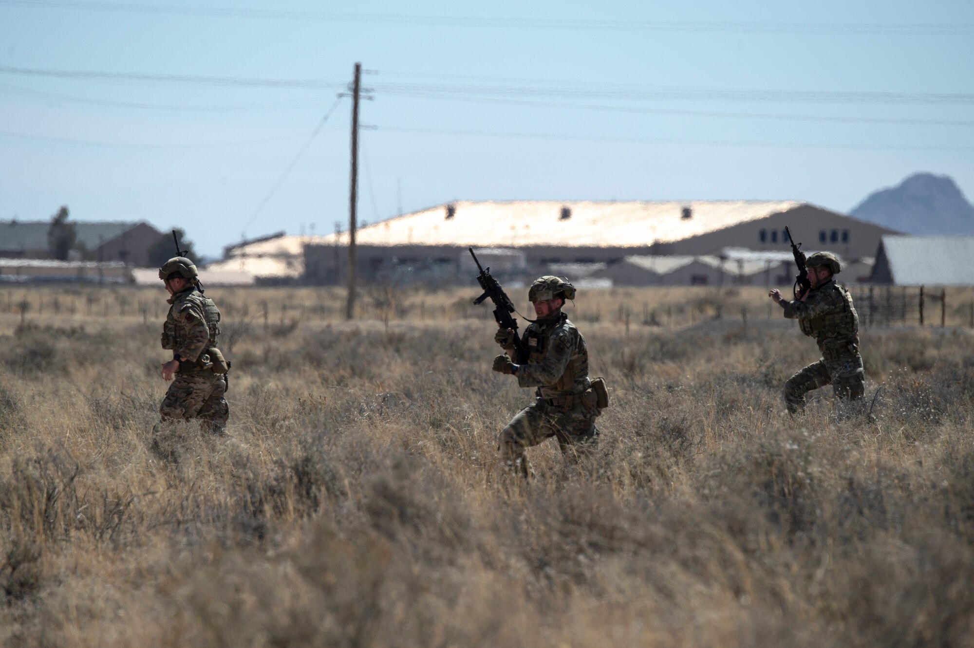 Airmen from the 49th Security Forces Squadron execute tactical movements during the first-ever Fire Team Leaders Course atHolloman Air Force Base, New Mexico, Feb. 28, 2023.This course was meant to provide a better understanding of what is required for noncommissioned officers and Airmen Defenders in a combat-heavy environment. (U.S. Air Force photo by Senior Airman Antonio Salfran)