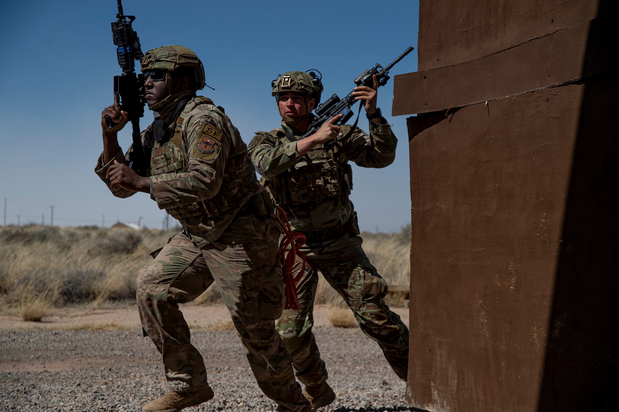 U.S. Air Force Senior Airman Aaron Fulmore, 49th Security Forces Squadron base defense operations center controller, left, and U.S. Air Force Senior Airman Constantino Starkey, 49th SFS patrolman, move to their next position after providing cover for their team in a small unit tactical movement exercise during the first-ever-ever Fire Team Leaders Course at Holloman Air Force Base, New Mexico, March 1, 2023. The course placed heavy emphasis on small-arms marksmanship fundamentals, mission planning, operations in urban environments, small unit tactics, and the overall ability to shoot, move and communicate. (U.S. Air Force photo by Senior Airman Antonio Salfran)