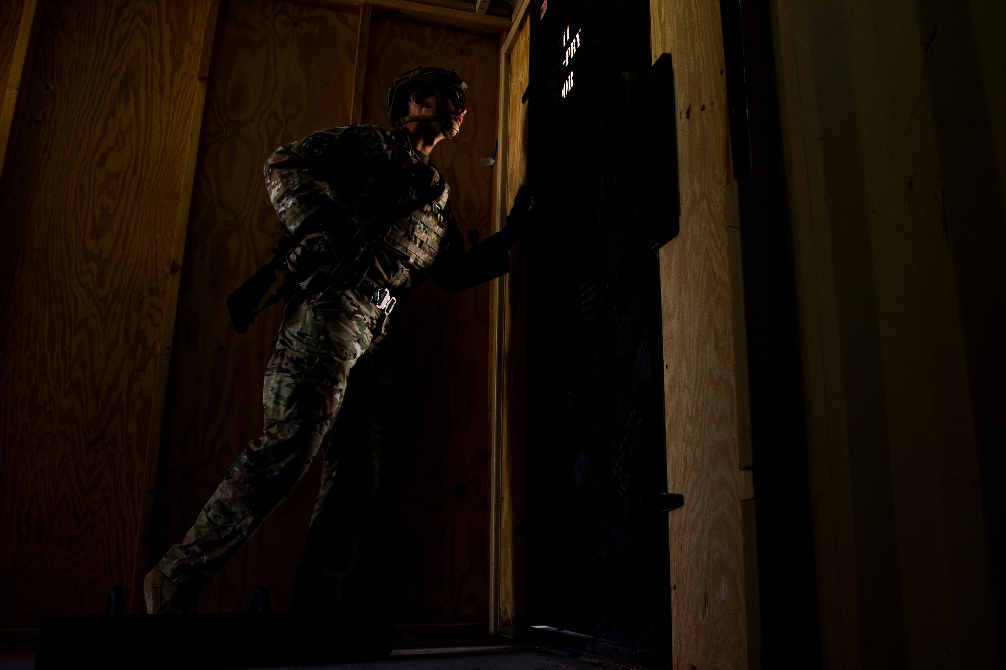 U.S. Air Force Staff Sgt. Chandler Docusen, 49th Security Forces Squadron training instructor, waits for cadre to clear a doorway in a breaching exercise during the first-ever-ever Fire Team Leaders Course at Holloman Air Force Base, New Mexico, March 1, 2023. The FTLC course allowed Airmen to learn the basics of breaching entryways with specialized equipment along with the foundational steps to effectively conduct close-quarters combat. (U.S. Air Force photo by Senior Airman Antonio Salfran)