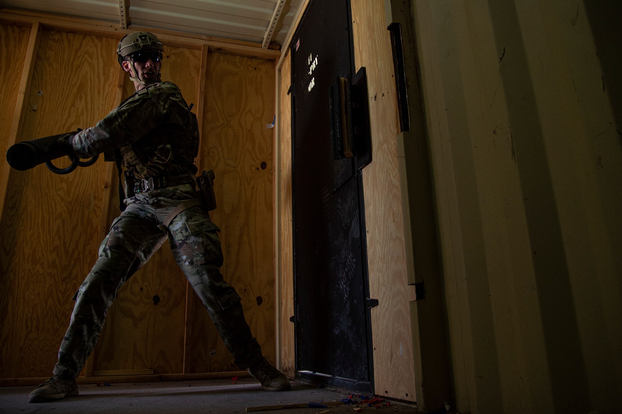U.S. Air Force Staff Sgt. Chandler Docusen, 49th Security Forces Squadron training instructor, uses a battering ram to breach a door in a breaching exercise during the first-ever-ever Fire Team Leaders Course at Holloman Air Force Base, New Mexico, March 1, 2023. The FTLC course allowed Airmen to learn the basics of breaching entryways with specialized equipment along with the foundational steps to effectively conduct close-quarters combat. (U.S. Air Force photo by Senior Airman Antonio Salfran)