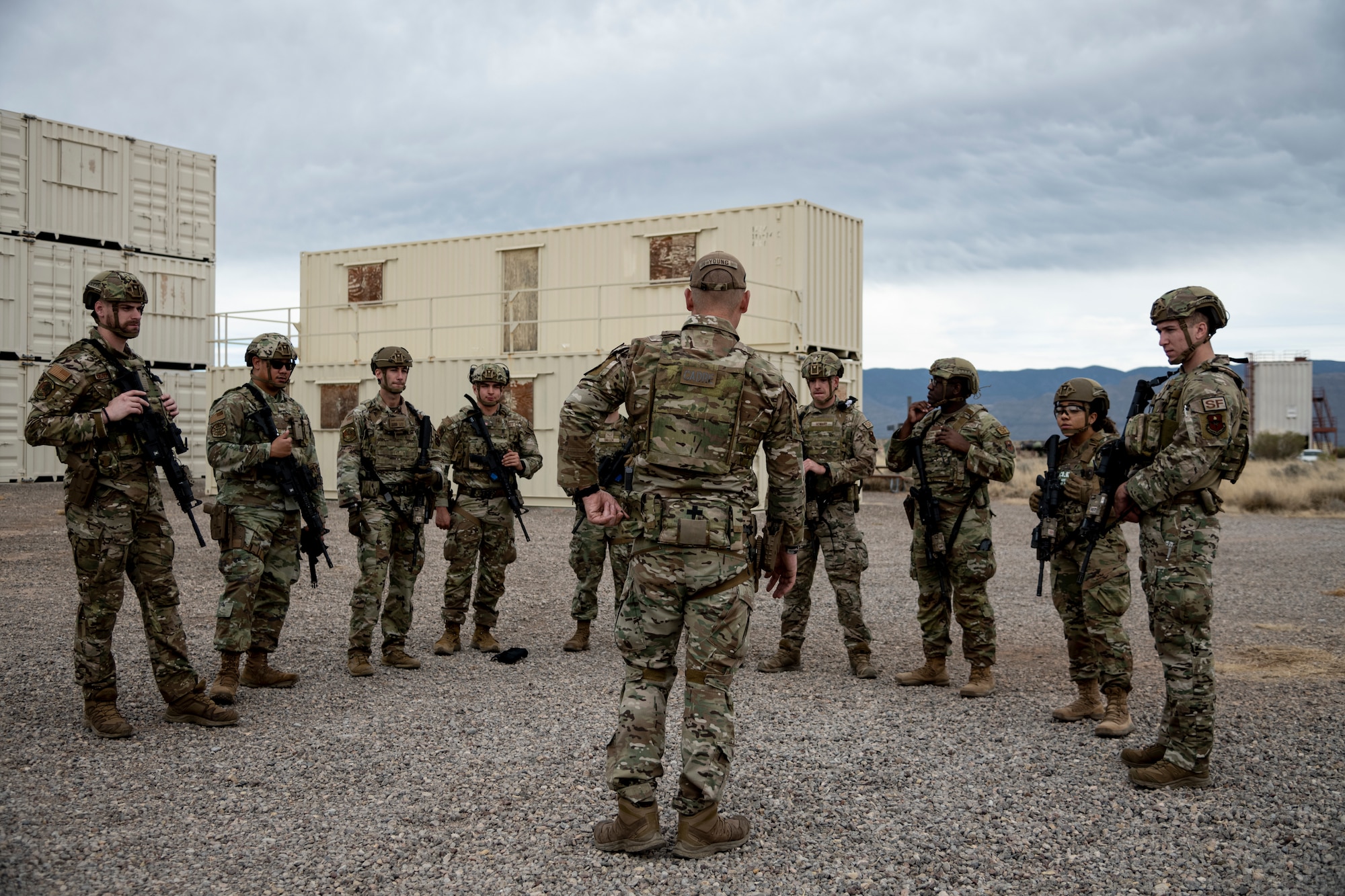 Airmen from the 49th Security Forces Squadron receive instruction during the first-ever-ever Fire Team Leaders Course at Holloman Air Force Base, New Mexico, Feb. 25, 2023. The FTLC is a seven-day training course that aims to improve the tactical skills and leadership capabilities of younger Security Forces noncommissioned officers and company-grade officers. (U.S. Air Force photo by Senior Airman Antonio Salfran)