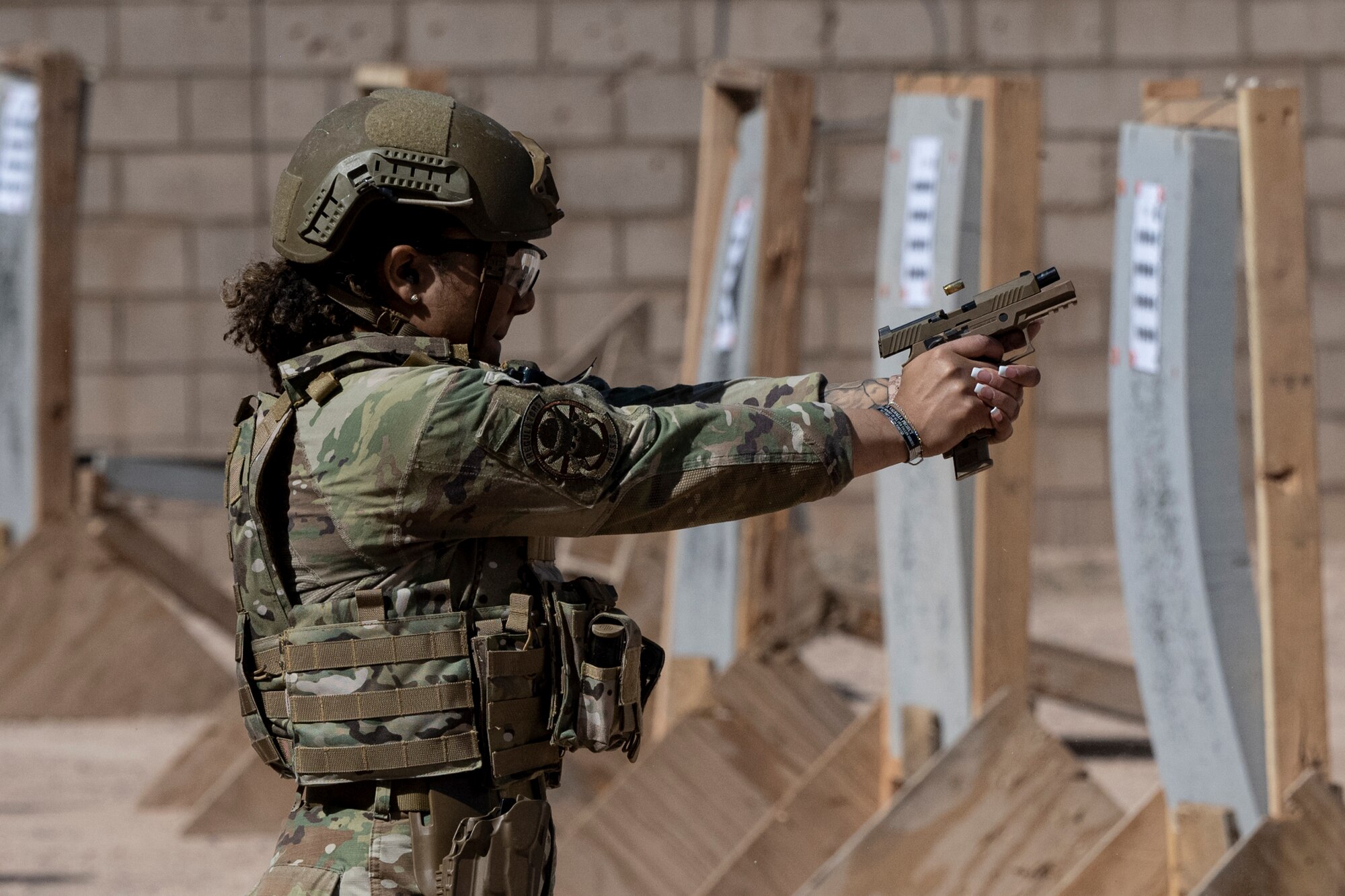 U.S. Air Force Senior Airman Randee Maclin, 49th Security Forces Squadron installation entry controller, fires an M18 pistol at the combat arms training range during the first-ever-ever Fire Team Leaders Course at Holloman Air Force Base, New Mexico, Feb. 26, 2023. This course provided a more comprehensive understanding of what is required for noncommissioned officers and Airmen Defenders in a combat-heavy environment. (U.S. Air Force photo by Senior Airman Antonio Salfran)