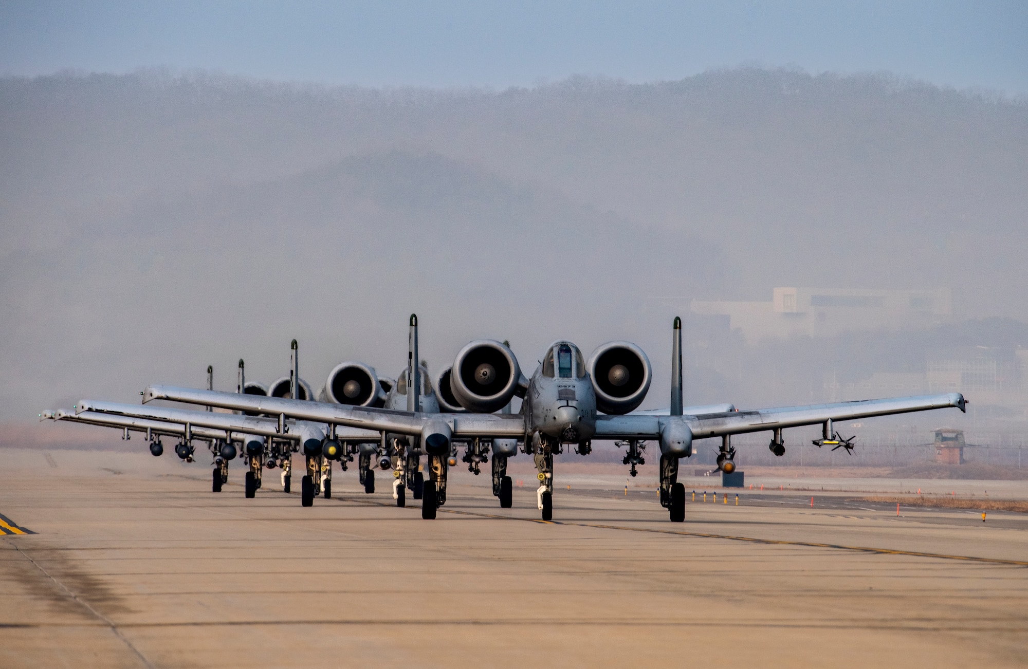 Four A-10C Thunderbolt II’s assigned to the 25th Fighter Squadron taxi on the runway before flight during Buddy Squadron 23-2 at Osan Air Base, Republic of Korea, March 8, 2023.