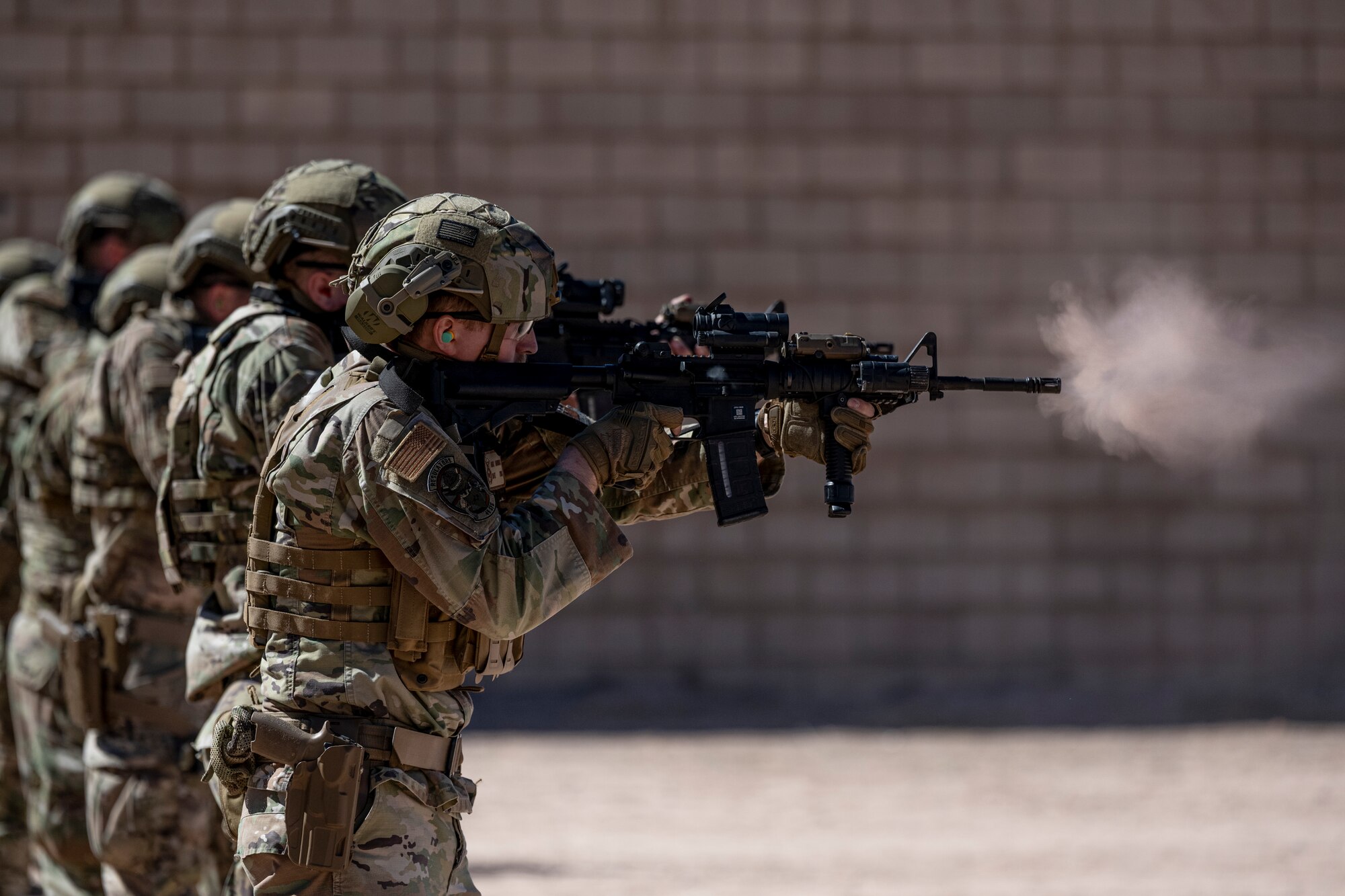 Airmen from the 49th Security Forces Squadron discharge their M4A1 Carbine at the combat arms training range during the first-ever-ever Fire Team Leaders Course at Holloman Air Force Base, New Mexico, Feb. 27, 2023. The fully automatic M4A1 Carbine rifle is an upgrade to the semiautomatic M4, which fires only a three-round burst. (U.S. Air Force photo by Senior Airman Antonio Salfran)