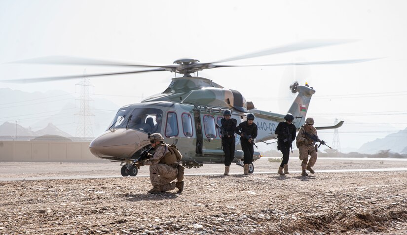 OMAN (February 23, 2023) – U.S. Marines assigned to Fleet Anti-Terrorism Security Team Central Command (FASTCENT) and members of the Royal Oman Police Special Task unit run from a Eurocopter EC225LP Super Puma after loading a simulated casualty during the final demonstration in exercise Invincible Sentry 23 in Oman Feb. 23. IS23 is a recurring exercise held with different partner nations each year within U.S. Central Command’s area of responsibility to evaluate the readiness and capabilities of U.S. and Omani forces responding to a regional emergency. (U.S. Marine Corps photo by Staff Sgt. Benjamin McDonald)