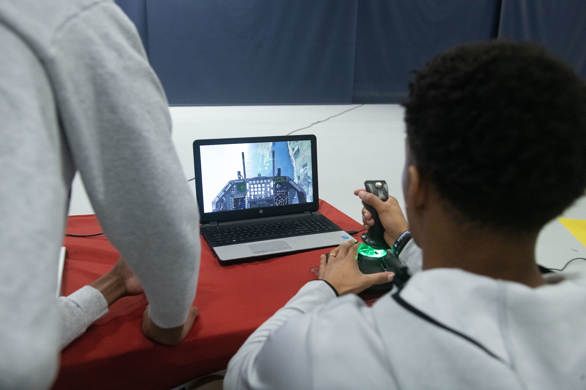A student flies an aircraft simulation during a Science, Technology, Engineering, Arts and Mathematics event at Joint Base Andrews, Md., March 9, 2023. The event was held to garner interest in military STEAM related career fields. (U.S. Air Force photo by Senior Airman Daekwon Stith)