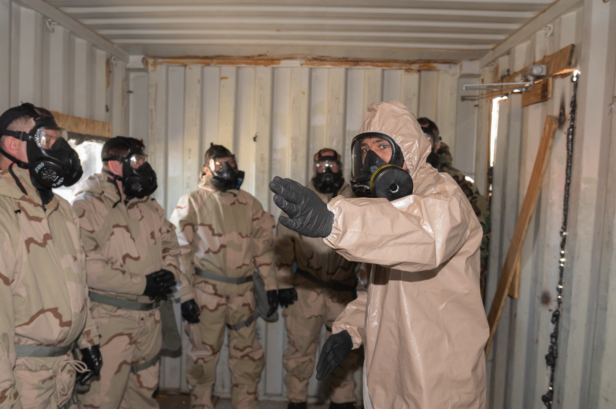 Master Sgt. Ritchie Brown, 436th Security Forces Squadron Tactics and Leadership Nexus course chief, points toward the gas chamber exit during a chemical, biological, radiological, and nuclear defense training during a readiness exercise at Dover Air Force Base, Delaware, March 7, 2023. The exercise tested the abilities of the 436th Airlift Wing to generate, employ and sustain airpower across the world in a contested and degraded operational environment. (U.S. Air Force photo by Mauricio Campino)