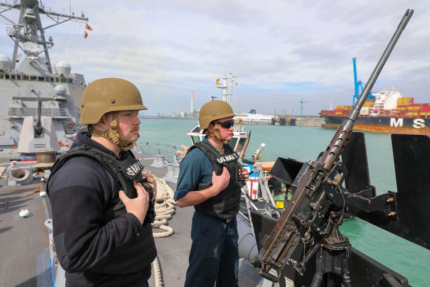 Gunners Mate 3rd Class Joshua Lesnar, left, and Gunners Mate 3rd Class Jesse Deese, both assigned to the Arleigh Burke-class guided-missile destroyer USS Delbert D. Black (DDG 119), stand small caliber action team watch while arriving in Civitavecchia, Italy for a scheduled port visit, March 11, 2023. The George H.W. Bush Carrier Strike Group is on a scheduled deployment in the U.S. Naval Forces Europe area of operations, employed by U.S. Sixth Fleet to defend U.S., allied, and partner interests.