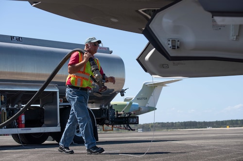 Barry Aston, Manning Aviation lineman, carries a fuel hose to a F-35A Lightning II in support of Agile Flag 23-1 at Brunswick Golden Isles Airport in Brunswick, Ga., March 5, 2023. Utilizing the Brunswick Golden Isles Airport, the Lead Wing simulated operating out of a contingency location consistent with Agile Combat Employment doctrine. (U.S. Air Force photo by Tech. Sgt. Joshua Edwards)