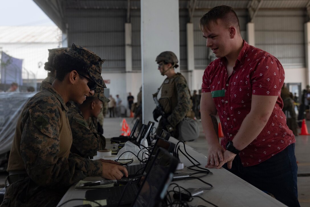 U.S. Marine Corps Cpl. Ianivette Cirino, a landing support specialist assigned to Combat Logistics Battalion 13, 13th Marine Expeditionary Unit, processes a simulated evacuee using the Non-Combatant Evacuation Operation Tracking System during Cobra Gold 23 in Chonburi province, Kingdom of Thailand on March 5, 2023.
