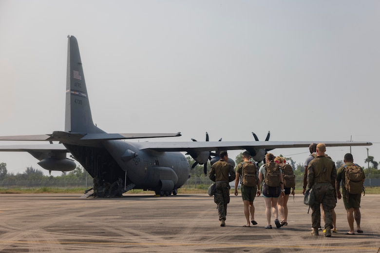 Simulated evacuees walk toward C-130 during Noncombatant Evacuation Operations (NEO) in the Kingdom of Thailand during Cobra Gold 23