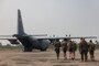 Simulated evacuees walk toward C-130 during Noncombatant Evacuation Operations (NEO) in the Kingdom of Thailand during Cobra Gold 23