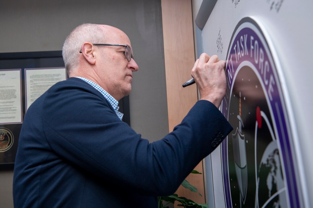 Man signing board