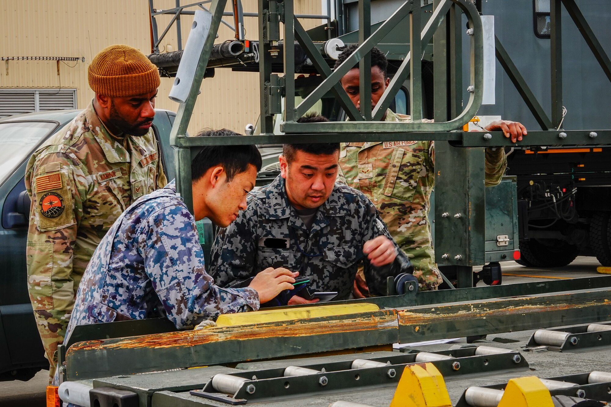 Service members work together on calculations.