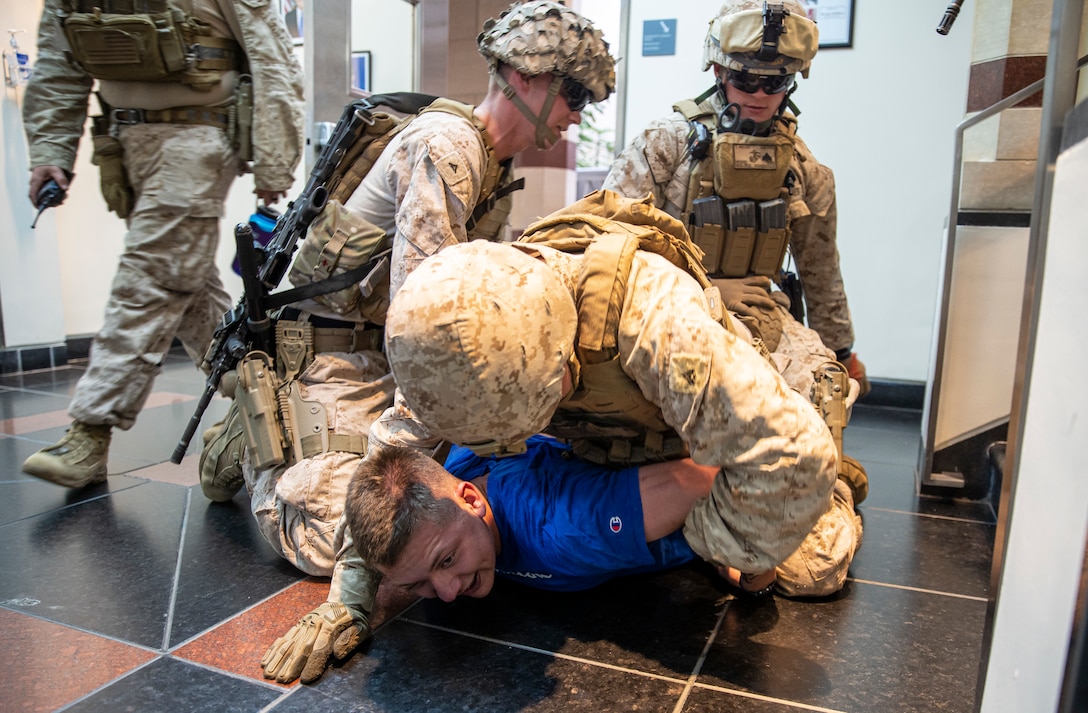 OMAN (February 24, 2023) – FASTCENT Marines detain a simulated intruder during an embassy reinforcement drill in Muscat, Oman.