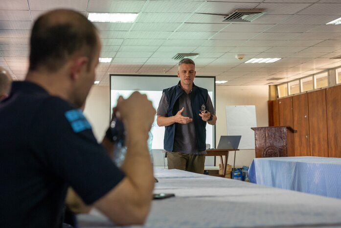 230307-N-FV745-1068 RAVLUNDA, Sweden (June 7, 2022) A International Criminal Police Organization (INTERPOL) agent discusses training items with members of the Georgian Coastguard Service members and members of the Mauritius Police Force (MPF) during exercise Cutlass Express 23, March 7, 2022. Cutlass Express 2023, conducted by U.S. Naval Forces Africa (NAVAF) and sponsored by U.S. Africa Command (AFRICOM) is designed to assess and improve combined maritime law enforcement techniques, promote safety and security in the Western Indian Ocean, and increase interoperability between participating nations. U.S. Sixth Fleet, headquartered in Naples, Italy, conducts the full spectrum of joint and naval operations, often in concert with allied and interagency partners, in order to advance U.S. national interests and security and stability in Europe and Africa. (U.S. Navy photo by Mass Communication Specialist 1st Class Daniel James Lanari/Released)