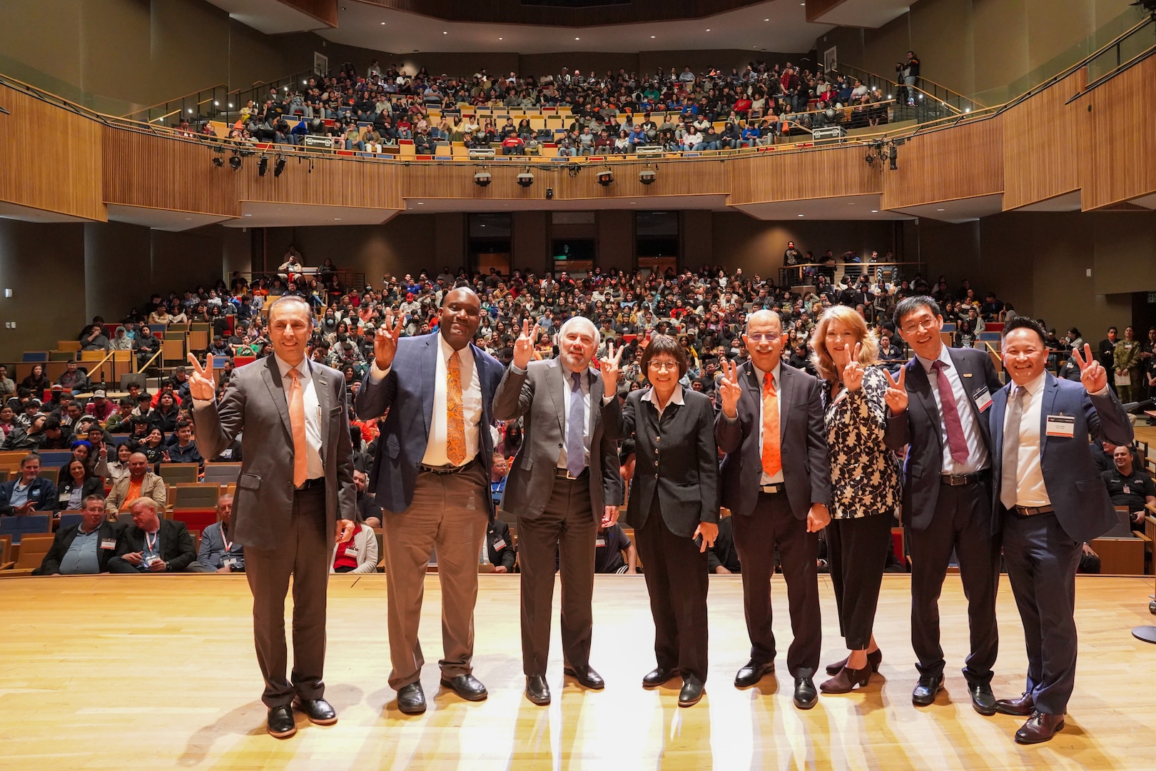 Special guests of the 2023 Manufacturing Expo and Exhibition at University of Texas Rio Grande Valley (UTRGV) in Edinburg give the UTRGV "V's Up," a single-hand sign representing the Vaqueros community, on Feb. 16, 2023. It is the same "v" sign used in American Sign Language, and represents the true spirit of the Vaqueros students, staff, faculty and the greater community. From left are: Dr. Can Saygin, Sr., UTRGV Vice President of Research; Dr. Archie L. Holmes Jr., Executive Vice Chancellor for Academic Affairs, UT system; Dr. Guy Bailey, UTRGV President; Honorable Heidi Shyu, Under Secretary of Defense for Research and Engineering; Dr. Ala Qubbaj, UTRGV Dean for the College of Engineering and Computer Science; Dr. Cindy Waters, Carderock SSTM for Advanced Manufacturing and Materials; Dr. James Li, Director of I-DREAM4D; and Louie Lopez, DoD STEM, Director. (Photo provided by Dr. Cynthia Waters)