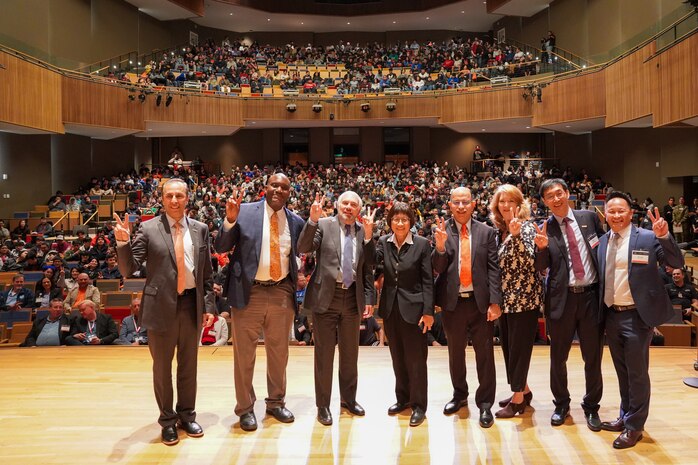 Special guests of the 2023 Manufacturing Expo and Exhibition at University of Texas Rio Grande Valley (UTRGV) in Edinburg give the UTRGV "V's Up," a single-hand sign representing the Vaqueros community, on Feb. 16, 2023. It is the same "v" sign used in American Sign Language, and represents the true spirit of the Vaqueros students, staff, faculty and the greater community. From left are: Dr. Can Saygin, Sr., UTRGV Vice President of Research; Dr. Archie L. Holmes Jr., Executive Vice Chancellor for Academic Affairs, UT system; Dr. Guy Bailey, UTRGV President; Honorable Heidi Shyu, Under Secretary of Defense for Research and Engineering; Dr. Ala Qubbaj, UTRGV Dean for the College of Engineering and Computer Science; Dr. Cindy Waters, Carderock SSTM for Advanced Manufacturing and Materials; Dr. James Li, Director of I-DREAM4D; and Louie Lopez, DoD STEM, Director. (Photo provided by Dr. Cynthia Waters)